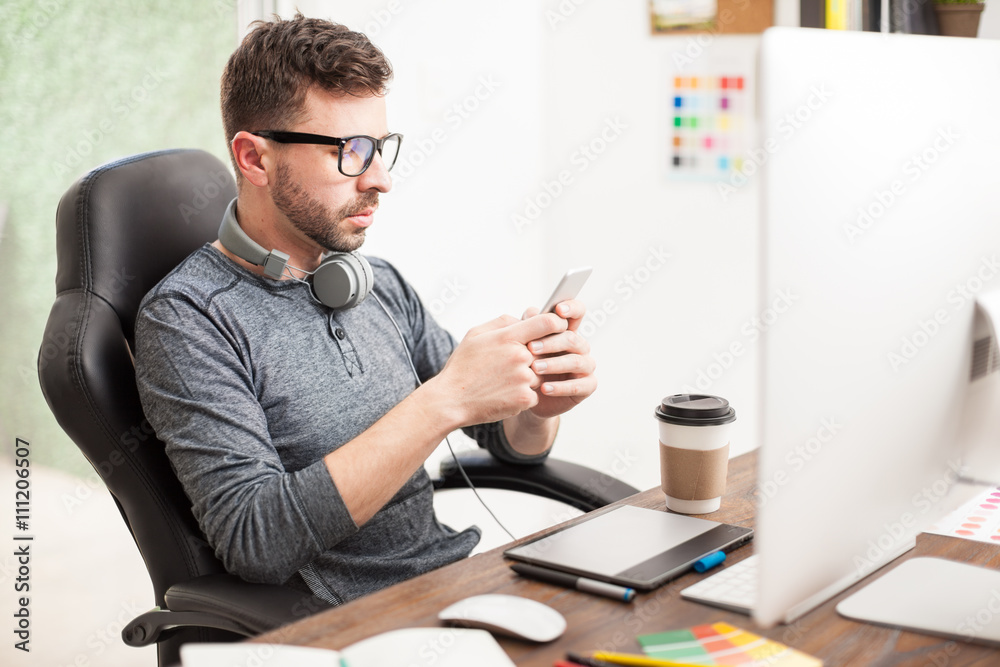 Young man texting at the office Young man texting at the office