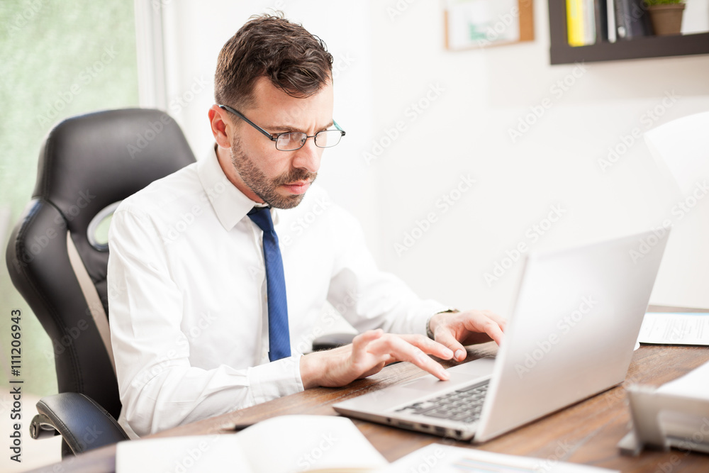 Businessman with glasses working on a laptop Businessman with glasses working on a laptop