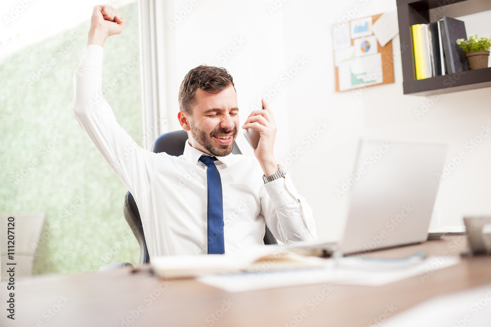 Businessman just got a new client over the phone Businessman just got a new client over the phone