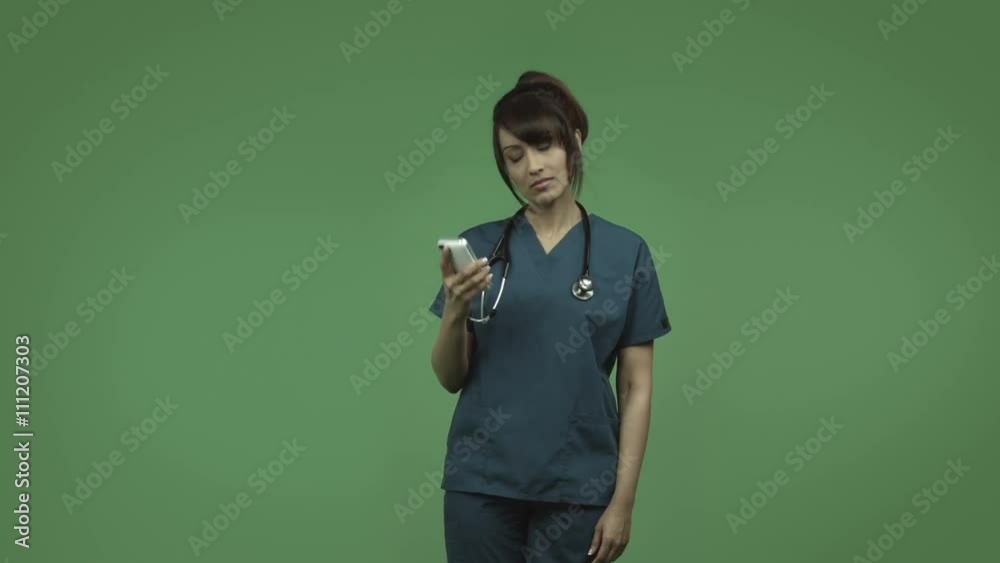 indian female doctor isolated on greenscreen upset with cell phone indian female doctor isolated on greenscreen upset with cell phone