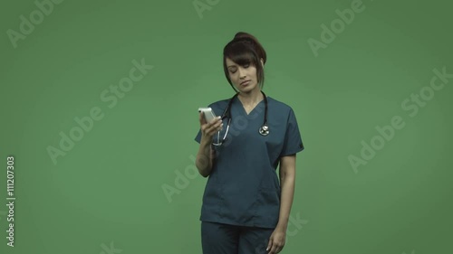 indian female doctor isolated on greenscreen upset with cell phone photo