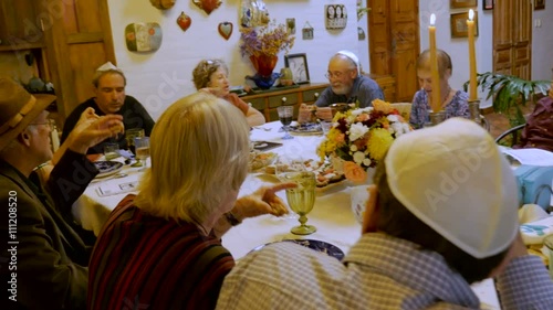 Hand held of people eating matzah at a Passover seder