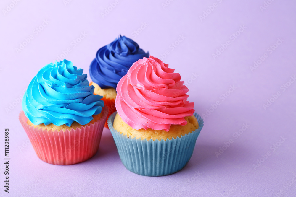 Birthday cupcakes on purple background