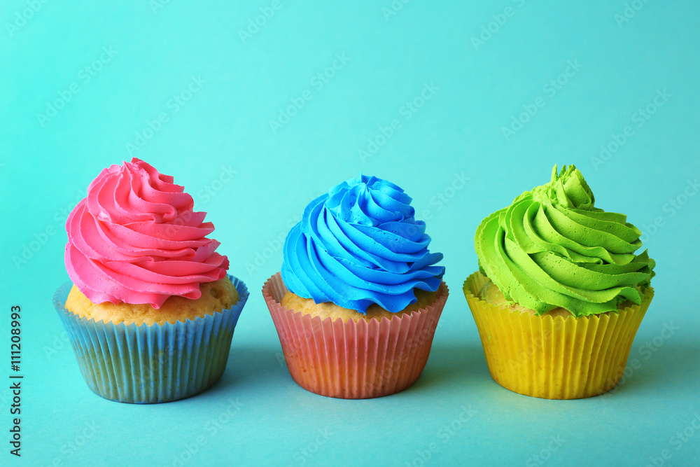 Birthday cupcakes on turquoise background Birthday cupcakes on turquoise background