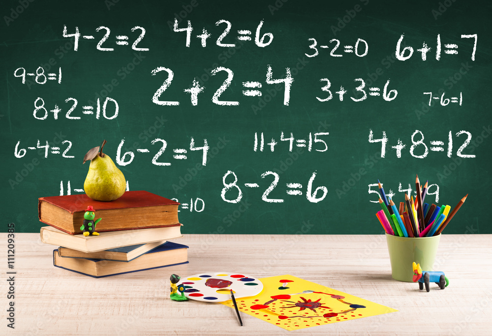 School blackboard with pile of books School blackboard with pile of books