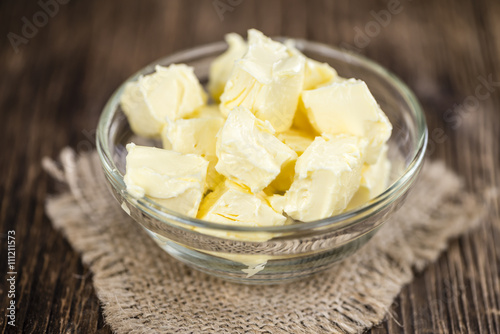 Piece of Butter on wooden background (selective focus)