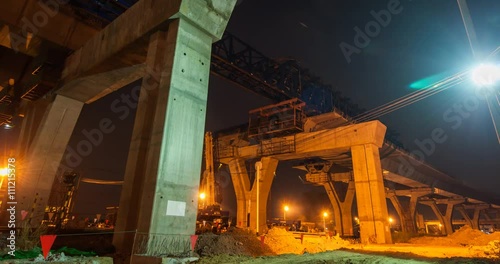 Timelapse night to dayt at express way construction site over rail road in Bangkok, Thailand photo