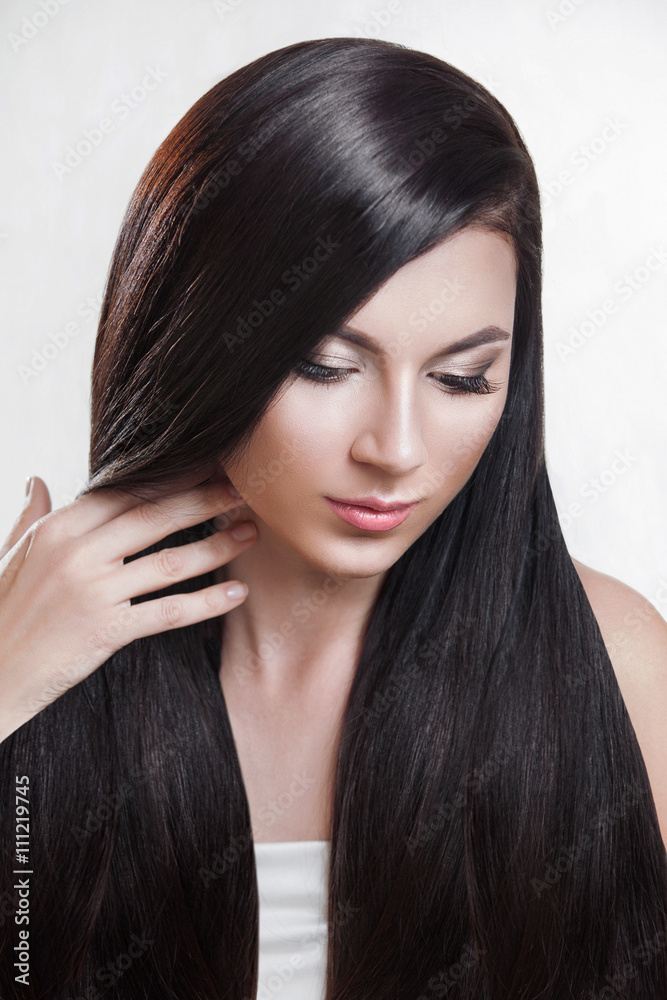 Naklejka premium Hair. Beautiful brunette girl . Healthy long hair .