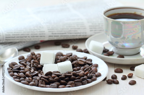 Cup of black coffee and newspapper photo