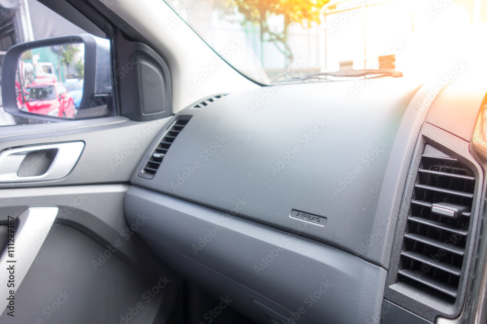 Car dashboard. Air conditioning system and airbag panel. Interior detail.