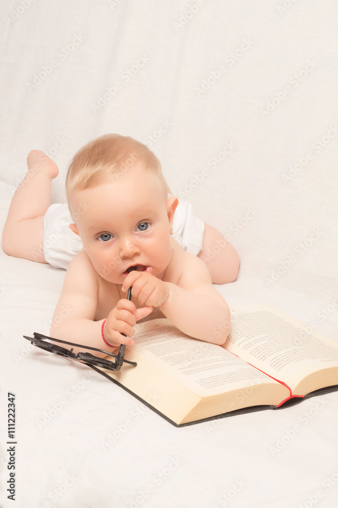baby girl with glasses reading a book baby girl with glasses reading a book
