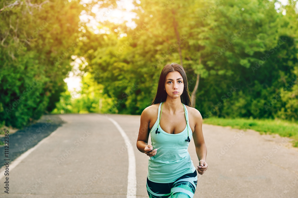 Young woman running in the Park . Sports girls Young woman running in the Park . Sports girls
