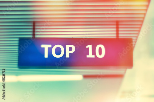 Word TOP 10  on advertising board with shiny bright colors