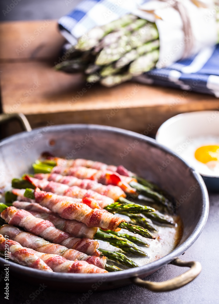 Asparagus. Asparagus and roll bacon. Grilled asparagus with rolled bacon and fried egg. Fried old pan full of rolled bacon with green asparagus and fried egg. Asparagus. Asparagus and roll bacon. Grilled asparagus with rolled bacon and fried egg. Fried old pan full of rolled bacon with green asparagus and fried egg.