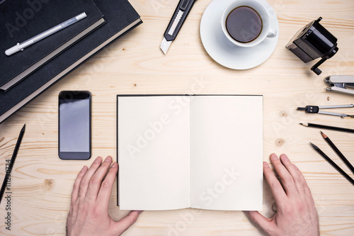 Man's hands, notepad and stationery