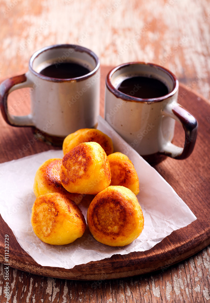Vanilla ricotta fritters and cups of coffee Vanilla ricotta fritters and cups of coffee