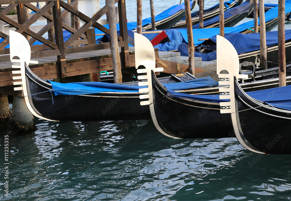 Venetian gondolas moored in landing passengers