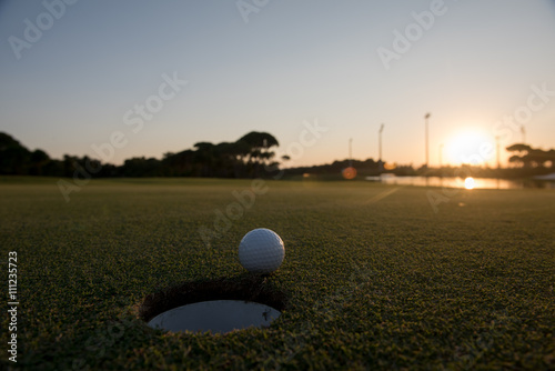 golf ball on edge of  the hole