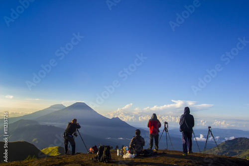 nature photographer in action during sunrise