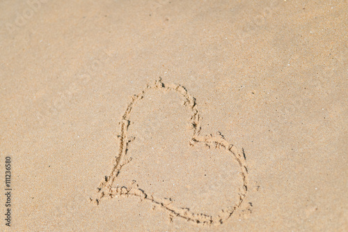 Top view on heart drawn in the sand. Beach background.  © aquar