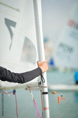  Hand holding sailboat mast on regatta