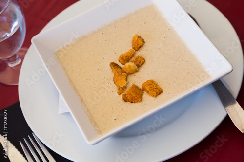 Creamy agaric soup served with sippets photo