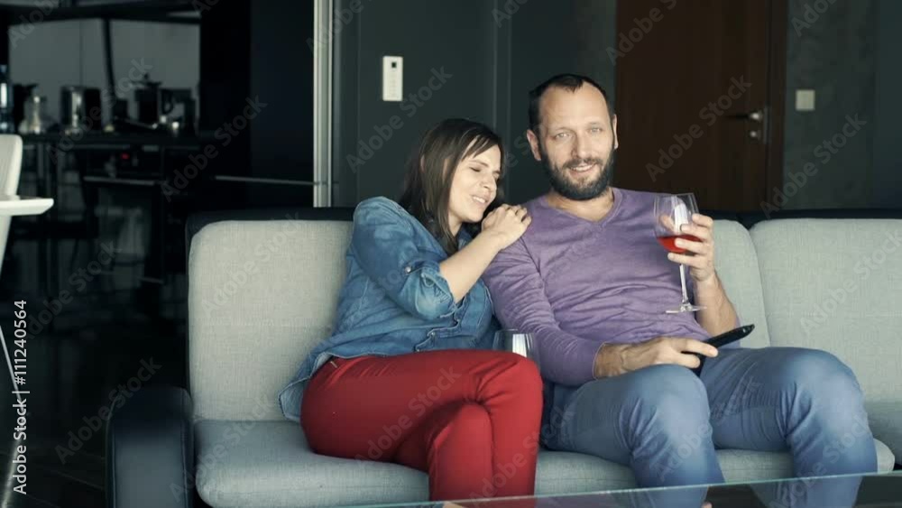 Young couple watching scary movie on TV sitting on sofa at home
Young couple watching scary movie on TV sitting on sofa at home
