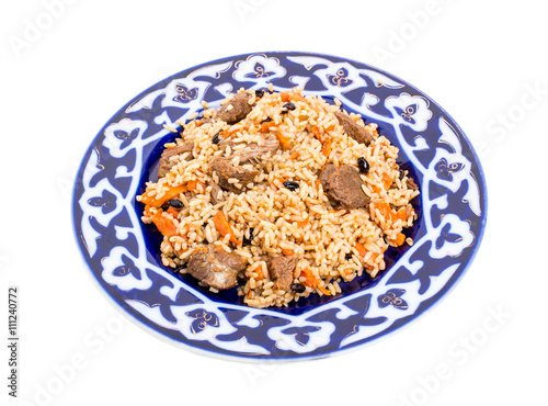 Fragrant pilaf with meat and dried apricots. © indigolotos