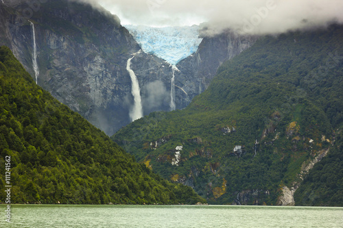 scenic view on glacier ventisquero calgante with waterfall, chilean patagonia