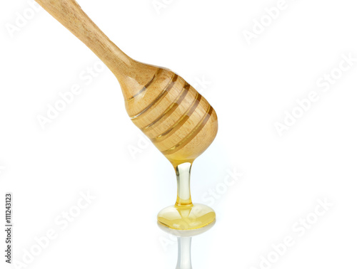 honey runs a honey dipper down isolated on white