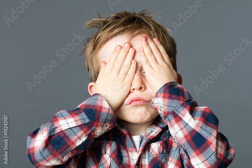 fun peekaboo for kid covering his eyes to be invisible photo