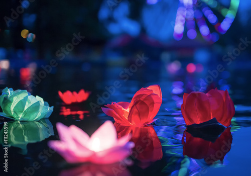 The glowing lanterns on the water