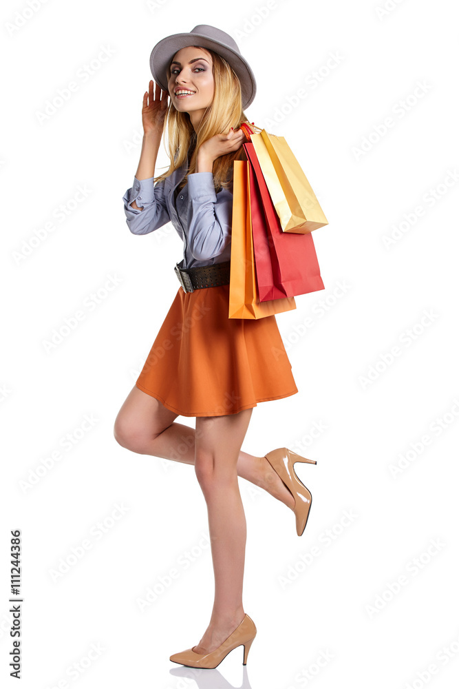 Shopping woman holding bags, isolated on white studio background