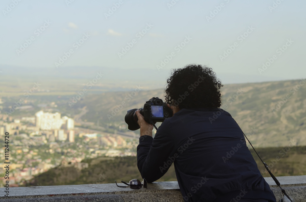 man photographs the city skyline