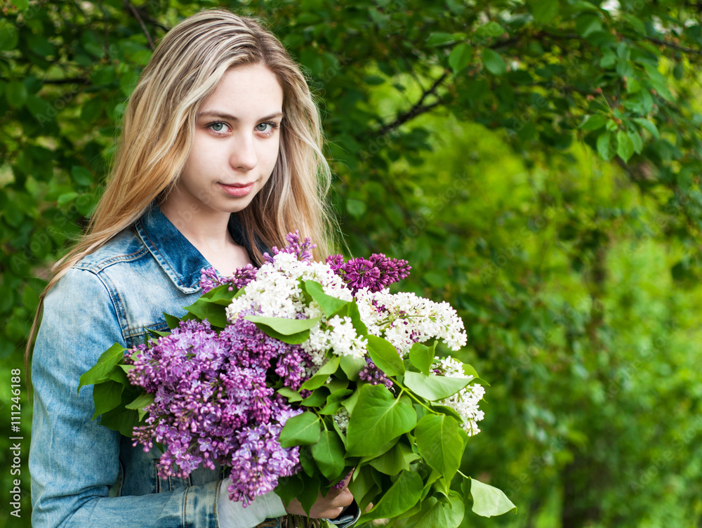 Girl with a bouquet of lilacs
