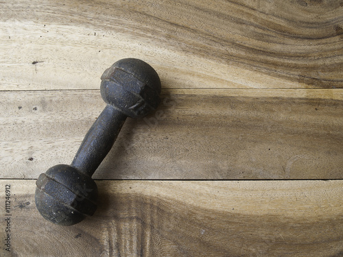 metal dumbbell on a old wooden background