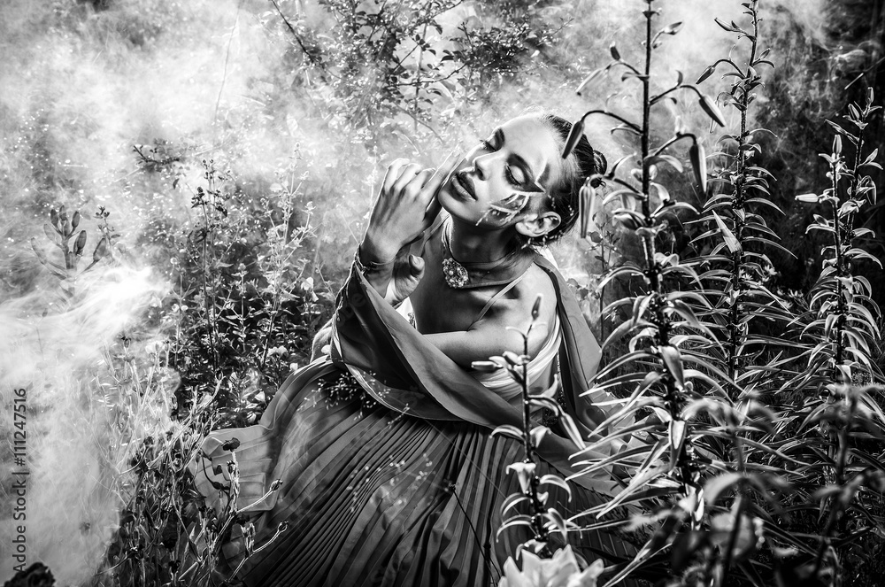 Obraz premium Attractive romantic woman on beautiful dress pose outdoor. Black-white fine art photo.