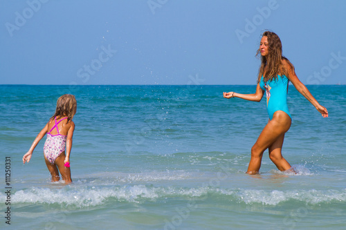 Mum with daughter on the beach