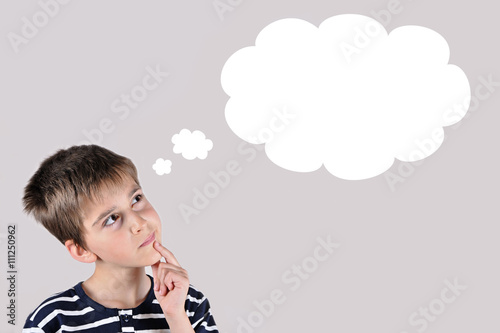 Thoughtful young boy with an empty thought bubble
