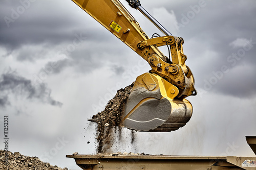 Construction industry excavator loading gravel closeup