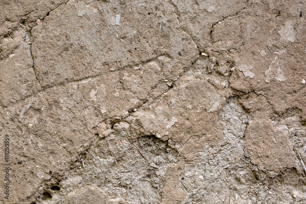 Cracked beige clay wall . Background. Texture Cracked beige clay wall . Background. Texture