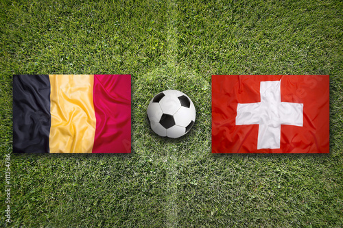 Belgium vs. Switzerland flags on soccer field