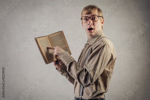 Surprised nerd holding a book photo