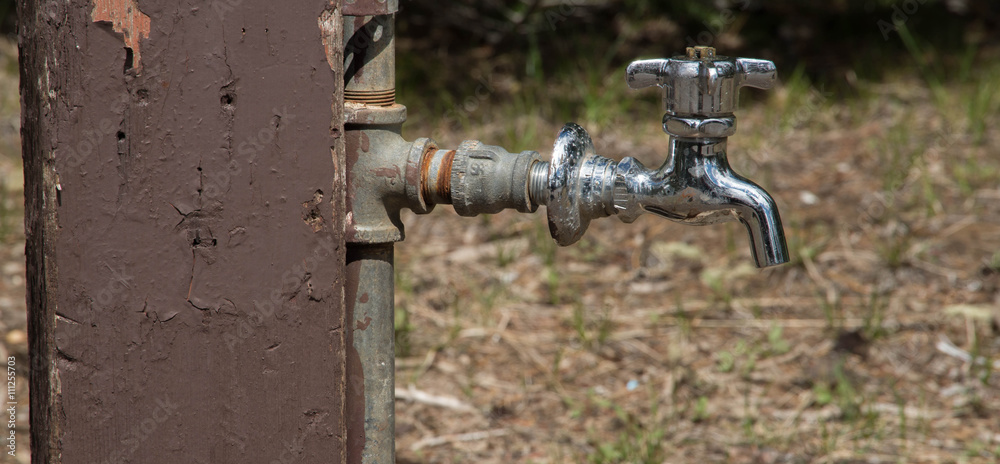 Chrome outdoor water faucet at a forest campground in central Oregon