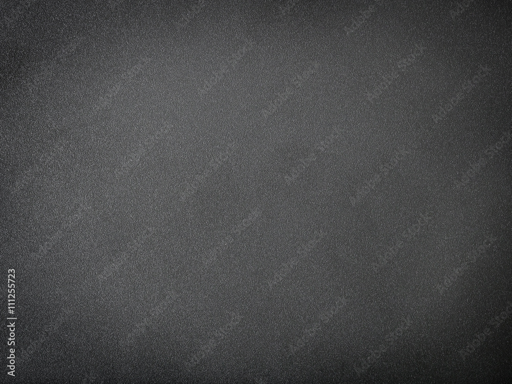 Grainy black textured background with spotlight Grainy black textured background with spotlight