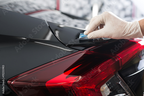Car detailing series : Closeup of hand coating black car paint