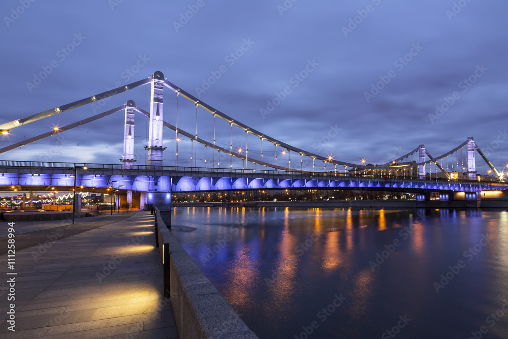 Krymsky Bridge or Crimean Bridge at night is a steel suspension bridge in Moscow, Russia