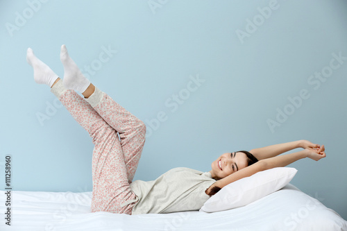Young woman in pajamas stre...