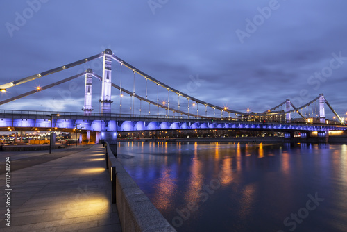 Krymsky Bridge or Crimean Bridge at night is a steel suspension bridge in Moscow, Russia