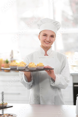 Female chef working at kitchen
